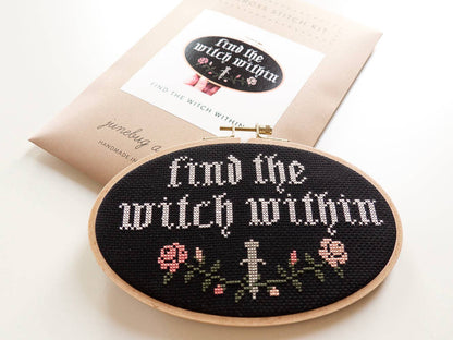 Embroidery hoop with 'Find the witch within' text and floral designs on a white background