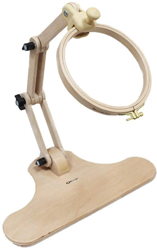 A wooden adjustable embroidery hoop stand with a curved base, articulated arms, and a light natural wood hoop, shown on a plain white background.
